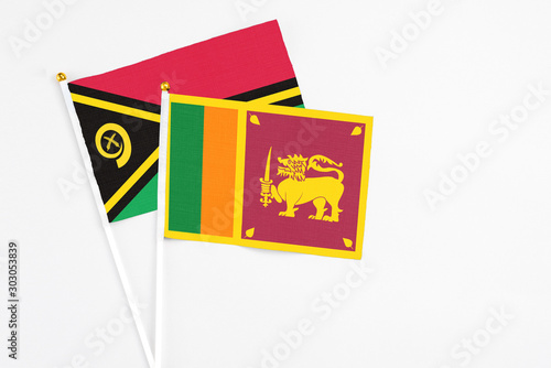 Sri Lanka and Vanuatu stick flags on white background. High quality fabric, miniature national flag. Peaceful global concept.White floor for copy space.