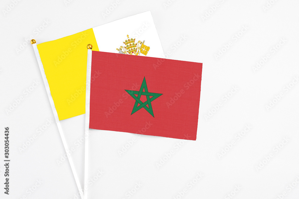 Morocco and Vatican City stick flags on white background. High quality fabric, miniature national flag. Peaceful global concept.White floor for copy space. Morocco and Vatican City stick flags on white background. High quality fabric, miniature national flag. Peaceful global concept.White floor for copy space.