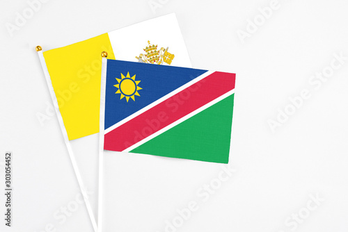 Free Download Namibia and Vatican City stick flags on white background. High quality fabric, miniature national flag. Peaceful global concept.White floor for copy space. - GFXLoad