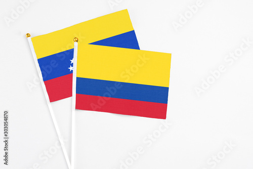 Free Download Colombia and Venezuela stick flags on white background. High quality fabric, miniature national flag. Peaceful global concept.White floor for copy space. - GFXLoad
