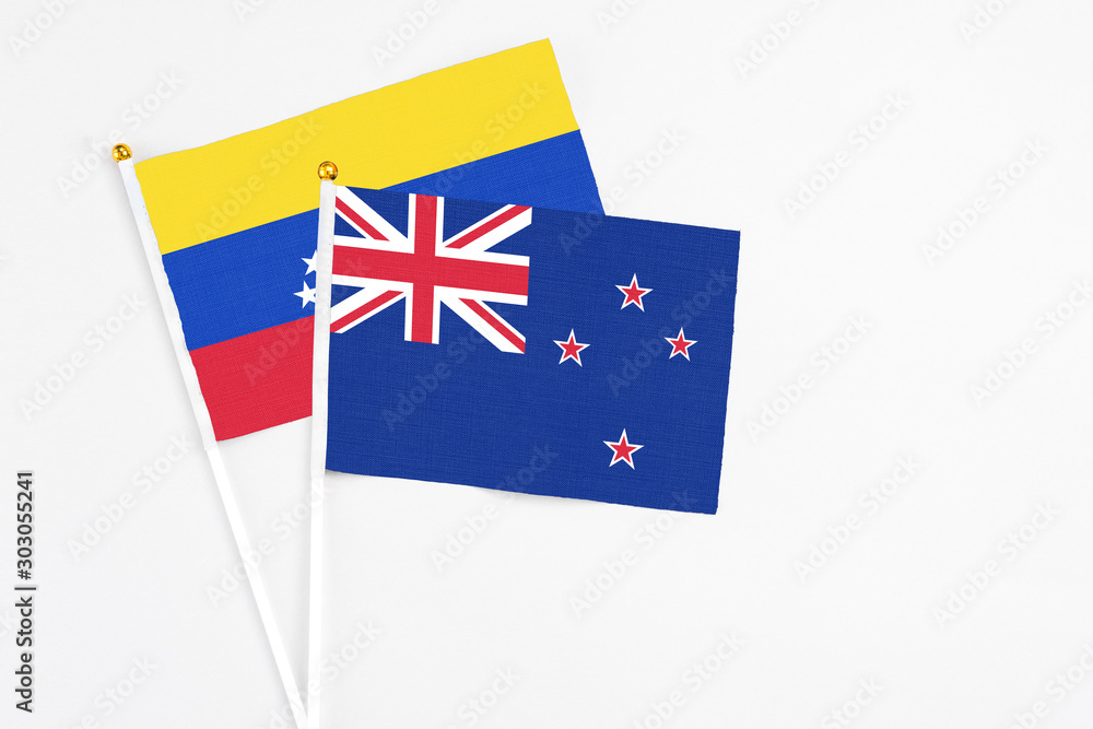 New Zealand and Venezuela stick flags on white background. High quality fabric, miniature national flag. Peaceful global concept.White floor for copy space. New Zealand and Venezuela stick flags on white background. High quality fabric, miniature national flag. Peaceful global concept.White floor for copy space.