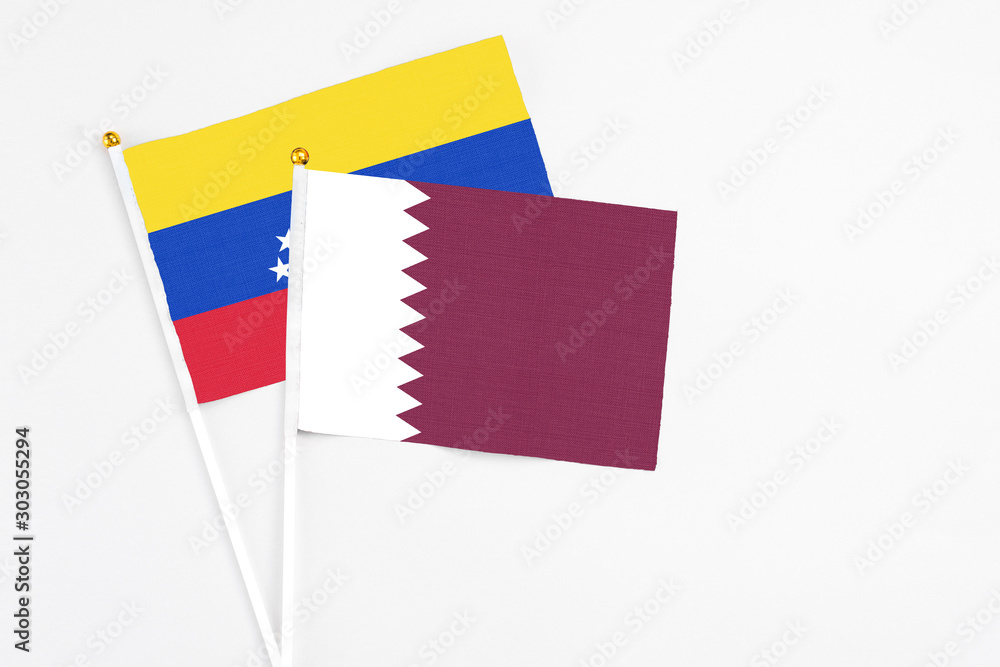 Qatar and Venezuela stick flags on white background. High quality fabric, miniature national flag. Peaceful global concept.White floor for copy space. Qatar and Venezuela stick flags on white background. High quality fabric, miniature national flag. Peaceful global concept.White floor for copy space.