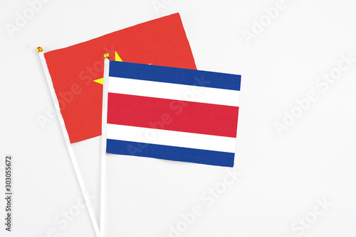 Costa Rica and Vietnam stick flags on white background. High quality fabric, miniature national flag. Peaceful global concept.White floor for copy space. Free Download Costa Rica and Vietnam stick flags on white background. High quality fabric, miniature national flag. Peaceful global concept.White floor for copy space. - GFXLoad