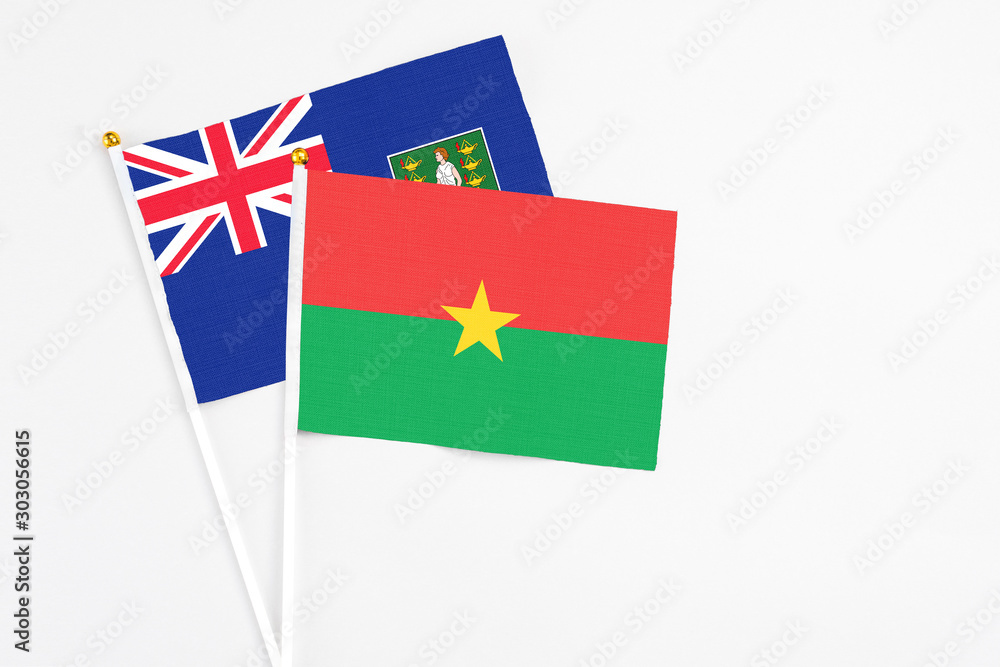 Burkina Faso and British Virgin Islands stick flags on white background. High quality fabric, miniature national flag. Peaceful global concept.White floor for copy space.