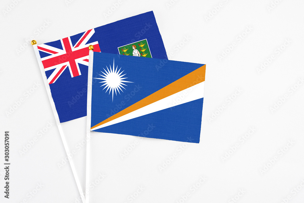 Marshall Islands and British Virgin Islands stick flags on white background. High quality fabric, miniature national flag. Peaceful global concept.White floor for copy space. Marshall Islands and British Virgin Islands stick flags on white background. High quality fabric, miniature national flag. Peaceful global concept.White floor for copy space.