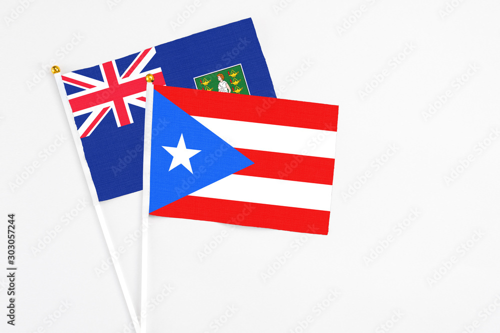 Puerto Rico and British Virgin Islands stick flags on white background. High quality fabric, miniature national flag. Peaceful global concept.White floor for copy space. Puerto Rico and British Virgin Islands stick flags on white background. High quality fabric, miniature national flag. Peaceful global concept.White floor for copy space.
