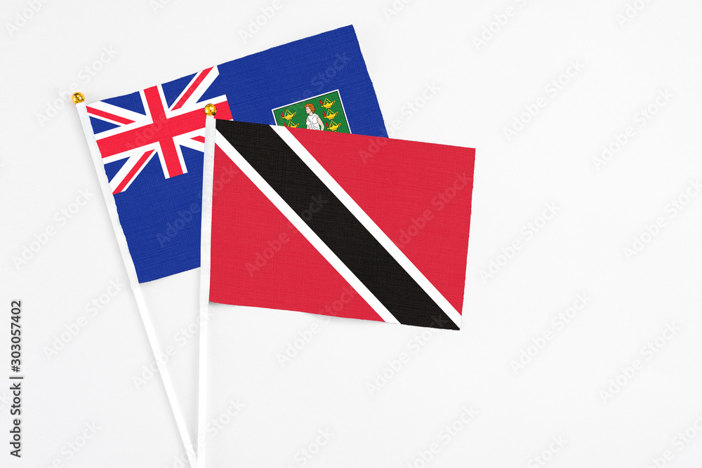Fototapeta premium Trinidad And Tobago and British Virgin Islands stick flags on white background. High quality fabric, miniature national flag. Peaceful global concept.White floor for copy space.