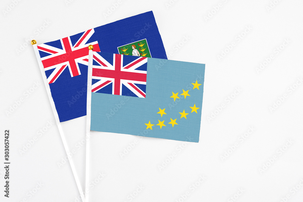 Tuvalu and British Virgin Islands stick flags on white background. High quality fabric, miniature national flag. Peaceful global concept.White floor for copy space. Tuvalu and British Virgin Islands stick flags on white background. High quality fabric, miniature national flag. Peaceful global concept.White floor for copy space.