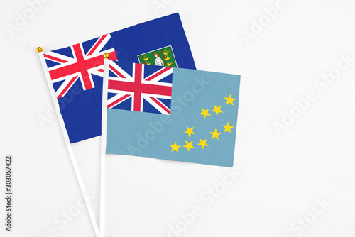 Tuvalu and British Virgin Islands stick flags on white background. High quality fabric, miniature national flag. Peaceful global concept.White floor for copy space. photo