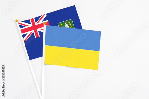 Ukraine and British Virgin Islands stick flags on white background. High quality fabric  miniature national flag. Peaceful global concept.White floor for copy space.
