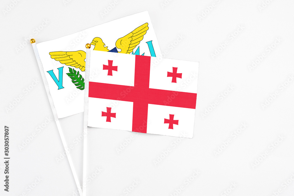 Georgia and United States Virgin Islands stick flags on white background. High quality fabric, miniature national flag. Peaceful global concept.White floor for copy space.