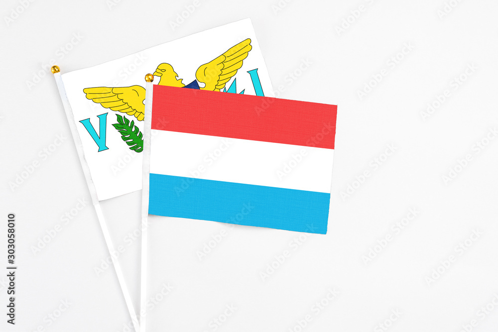 Luxembourg and United States Virgin Islands stick flags on white background. High quality fabric, miniature national flag. Peaceful global concept.White floor for copy space. Luxembourg and United States Virgin Islands stick flags on white background. High quality fabric, miniature national flag. Peaceful global concept.White floor for copy space.