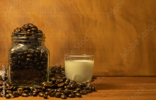 Coffee beans resting on a brown wooden table