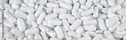 Εκτύπωση καμβά White pills spilled on blue wooden background
