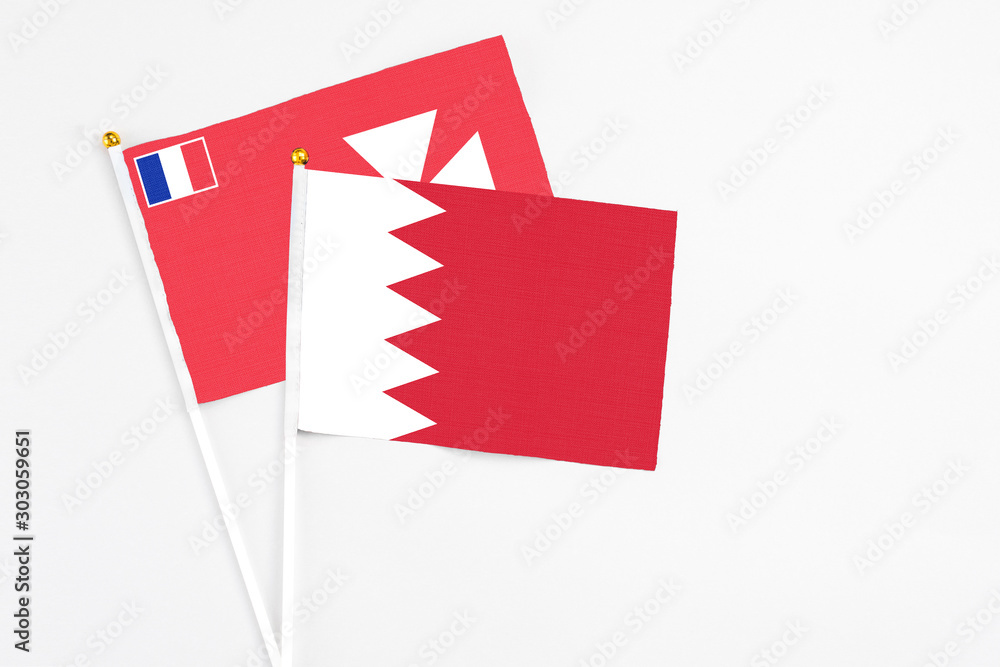 Bahrain and Wallis And Futuna stick flags on white background. High quality fabric, miniature national flag. Peaceful global concept.White floor for copy space. Bahrain and Wallis And Futuna stick flags on white background. High quality fabric, miniature national flag. Peaceful global concept.White floor for copy space.