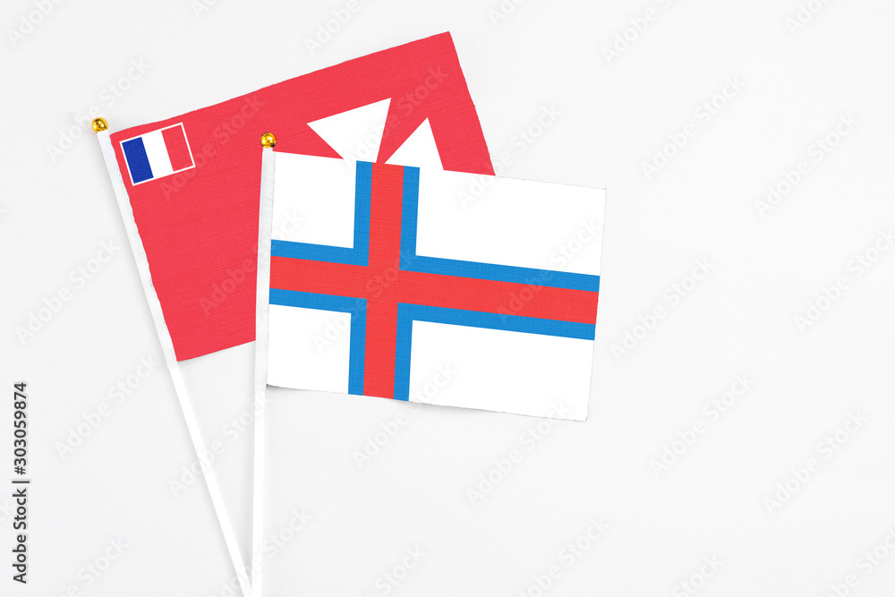Faroe Islands and Wallis And Futuna stick flags on white background. High quality fabric, miniature national flag. Peaceful global concept.White floor for copy space. Faroe Islands and Wallis And Futuna stick flags on white background. High quality fabric, miniature national flag. Peaceful global concept.White floor for copy space.