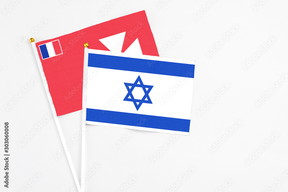 Fototapeta premium Israel and Wallis And Futuna stick flags on white background. High quality fabric, miniature national flag. Peaceful global concept.White floor for copy space.
