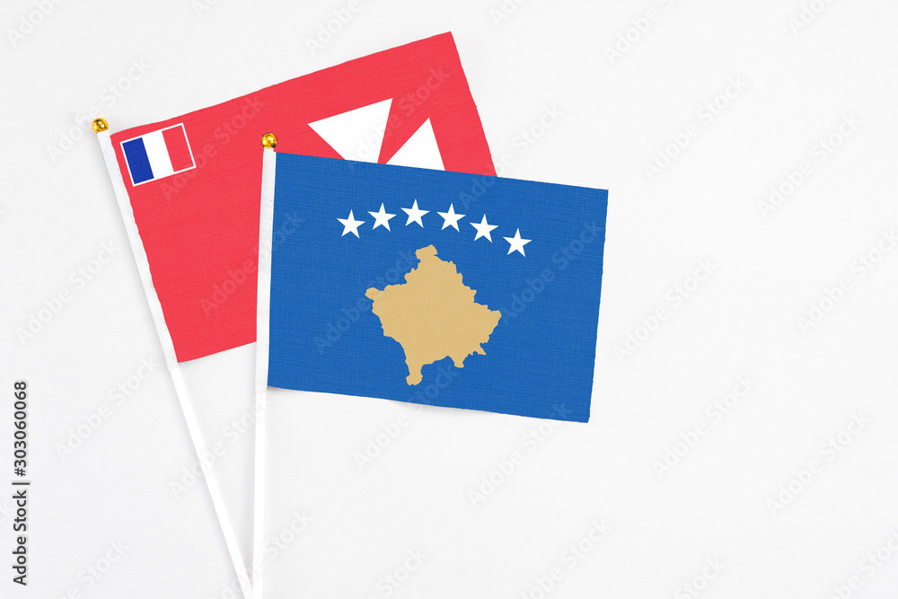Kosovo and Wallis And Futuna stick flags on white background. High quality fabric, miniature national flag. Peaceful global concept.White floor for copy space. Kosovo and Wallis And Futuna stick flags on white background. High quality fabric, miniature national flag. Peaceful global concept.White floor for copy space.