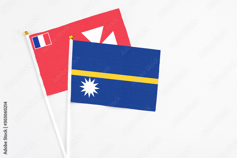 Nauru and Wallis And Futuna stick flags on white background. High quality fabric, miniature national flag. Peaceful global concept.White floor for copy space. Nauru and Wallis And Futuna stick flags on white background. High quality fabric, miniature national flag. Peaceful global concept.White floor for copy space.