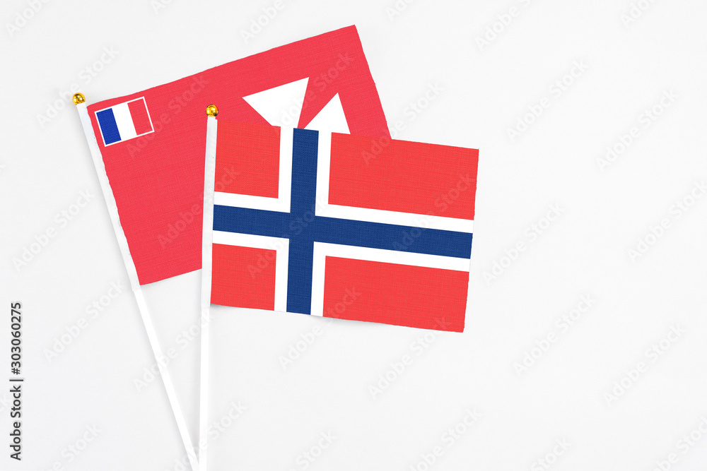 Norway and Wallis And Futuna stick flags on white background. High quality fabric, miniature national flag. Peaceful global concept.White floor for copy space.