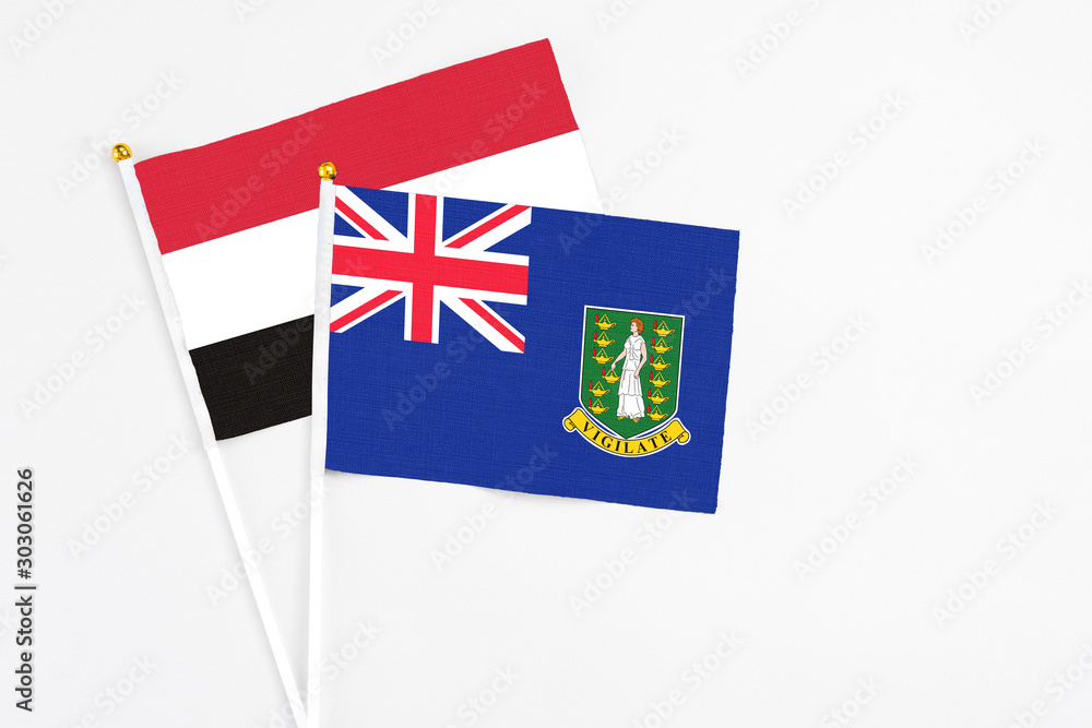 Fototapeta premium British Virgin Islands and Yemen stick flags on white background. High quality fabric, miniature national flag. Peaceful global concept.White floor for copy space.
