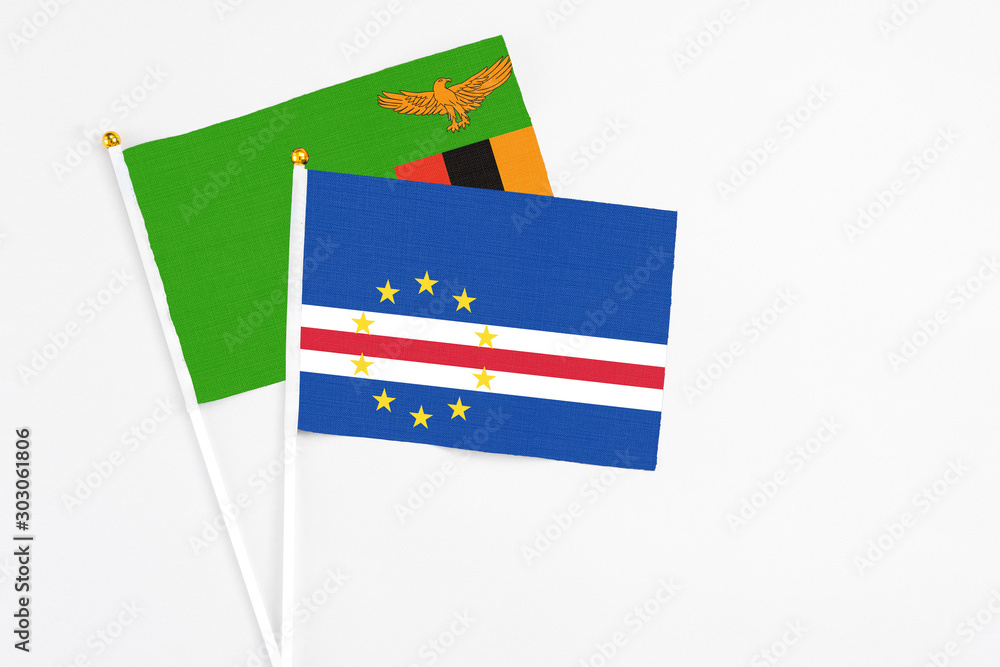 Cape Verde and Zambia stick flags on white background. High quality fabric, miniature national flag. Peaceful global concept.White floor for copy space. Cape Verde and Zambia stick flags on white background. High quality fabric, miniature national flag. Peaceful global concept.White floor for copy space.