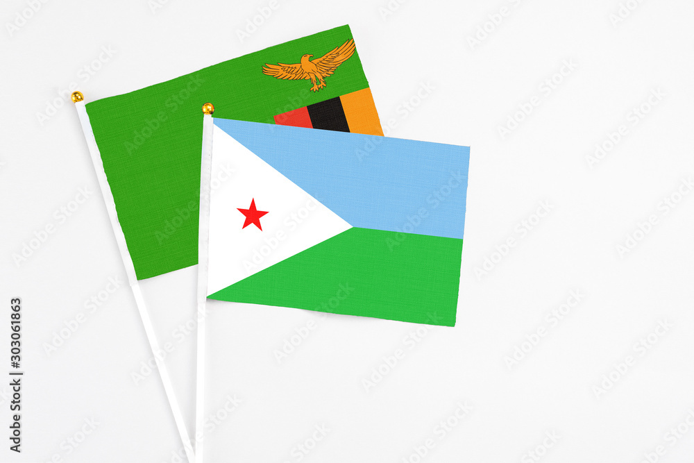 Djibouti and Zambia stick flags on white background. High quality fabric, miniature national flag. Peaceful global concept.White floor for copy space. Djibouti and Zambia stick flags on white background. High quality fabric, miniature national flag. Peaceful global concept.White floor for copy space.