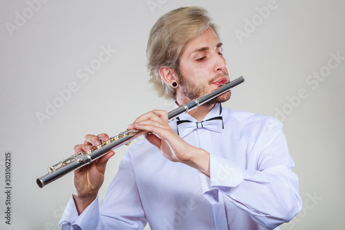 Fotografia, Obraz Male flutist playing his flute