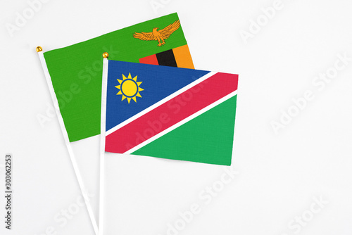 Namibia and Zambia stick flags on white background. High quality fabric, miniature national flag. Peaceful global concept.White floor for copy space. Free Download Namibia and Zambia stick flags on white background. High quality fabric, miniature national flag. Peaceful global concept.White floor for copy space. - GFXLoad