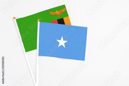 Free Download Somalia and Zambia stick flags on white background. High quality fabric, miniature national flag. Peaceful global concept.White floor for copy space. - GFXLoad
