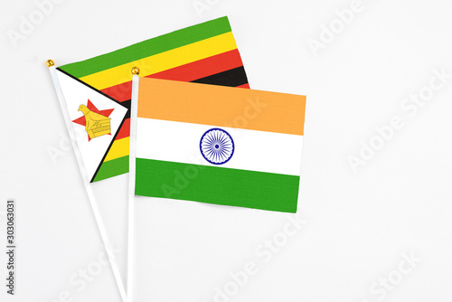 Free Download India and Zimbabwe stick flags on white background. High quality fabric, miniature national flag. Peaceful global concept.White floor for copy space. - GFXLoad