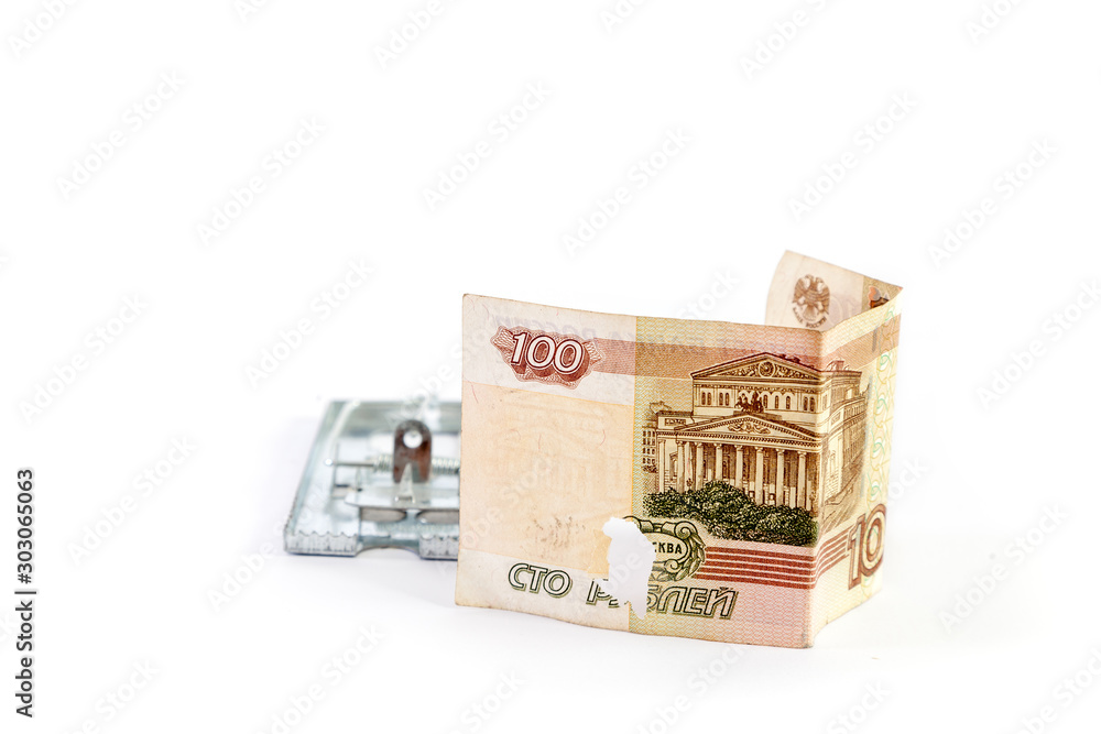 Banknote with defect and mousetrap on a white background Banknote with defect and mousetrap on a white background