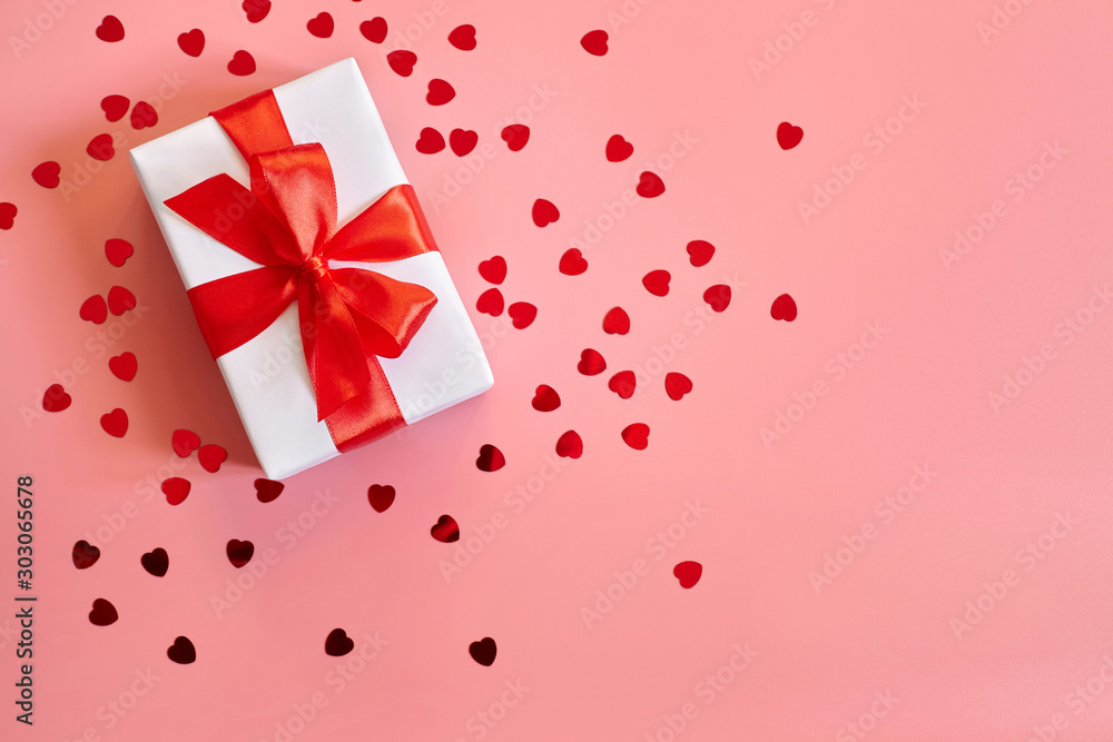 Gift box with red bow on pink background with copy space. Gift box with red bow on pink background with copy space.