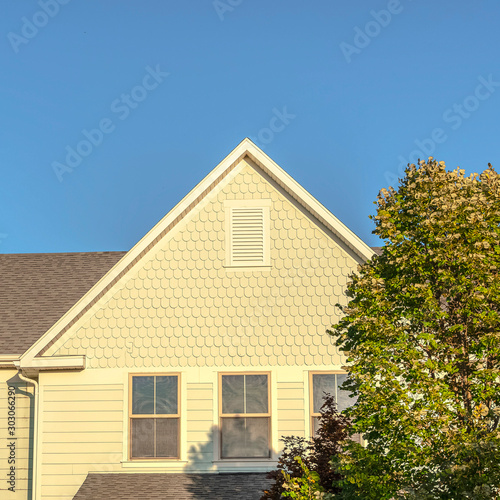 Square Facade of a large yellow house in evening light