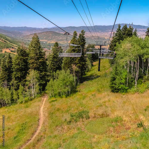Square Scenic mountain in Park City at off season with hiking trails under chairlifts