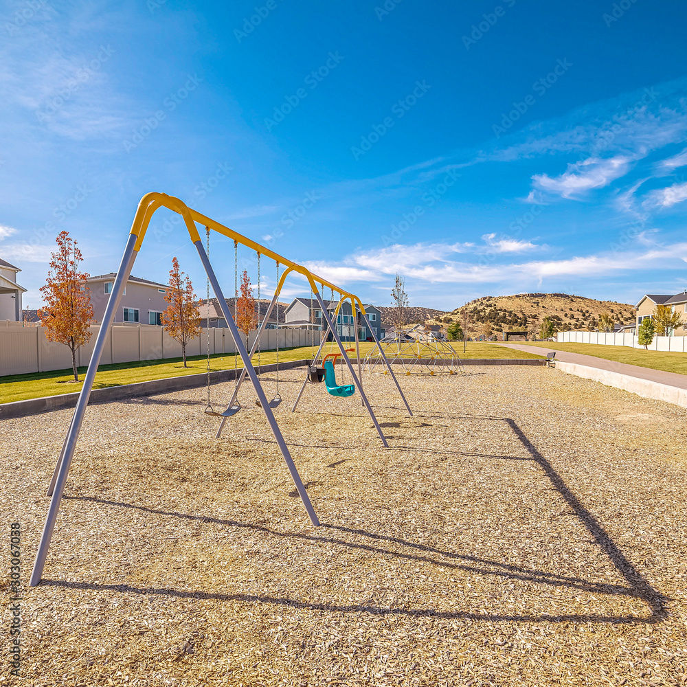 Fototapeta premium Square frame Set of A-frame kids swings in a residential park