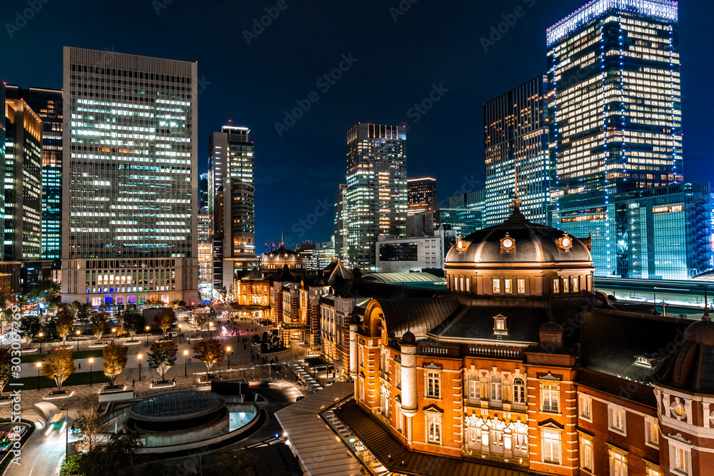 Night view of the brick-built facade on the western side of Tokyo Station (Marunouchi side) and the office buildings surrounding it.