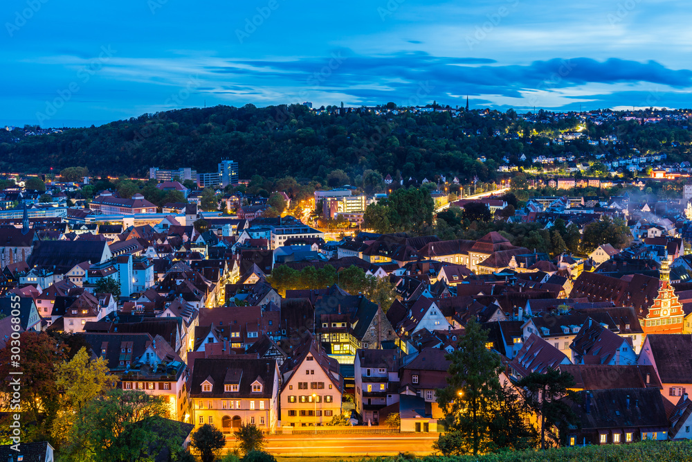 Germany, Twilight and magical lights of skyline of medieval village esslingen am neckar, aerial view above roofs, houses and street by night