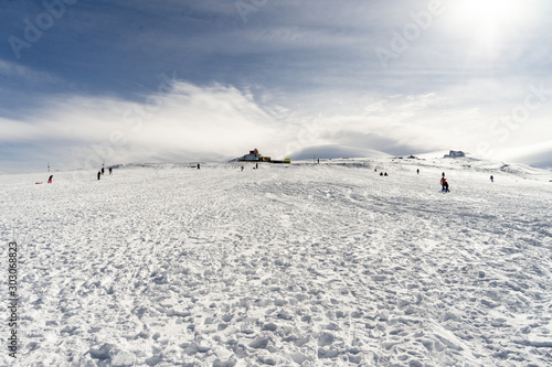 People having fun in snowed mountains in Sierra Nevada