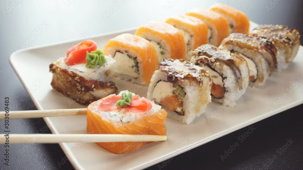 Closeup of chopsticks holding sushi. The view from the top. Closeup of chopsticks holding sushi. The view from the top.