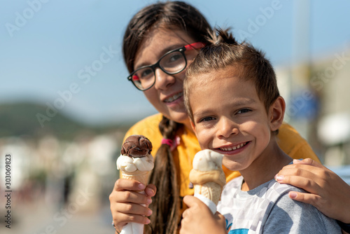 Girl and boy eating delicious ice cream