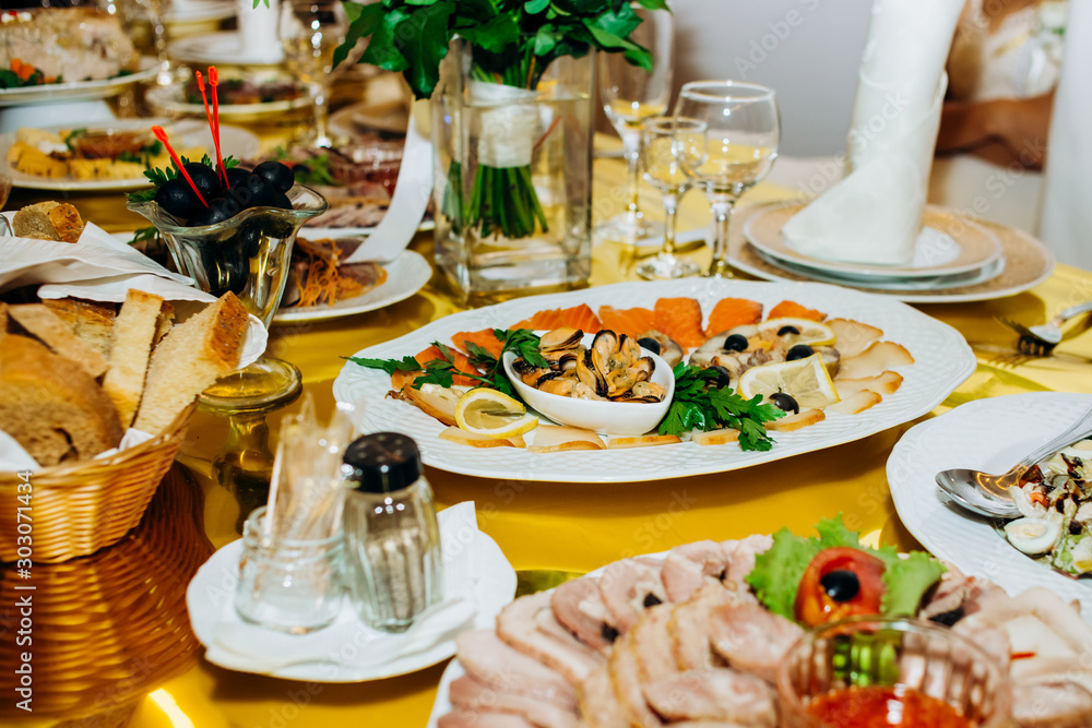 Beautifully decorated catering banquet table with different food snacks and appetizers on  wedding celebration, different snacks