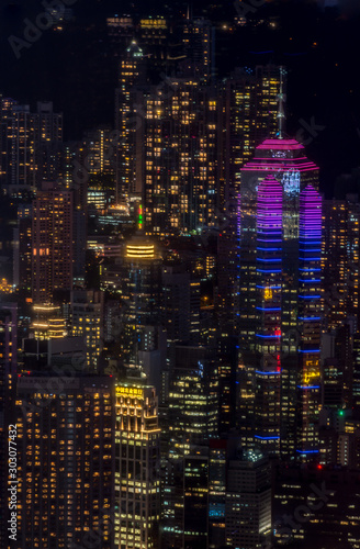 Hong Kong city lights, highlighting The Center building (at right); Dense, abstract view serves as a dark, colorful backdrop.