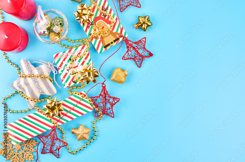 Christmas background with various Christmas decorations, colored garlands and beads, on a blue background. Christmas decorations. Christmas background. Space for text.