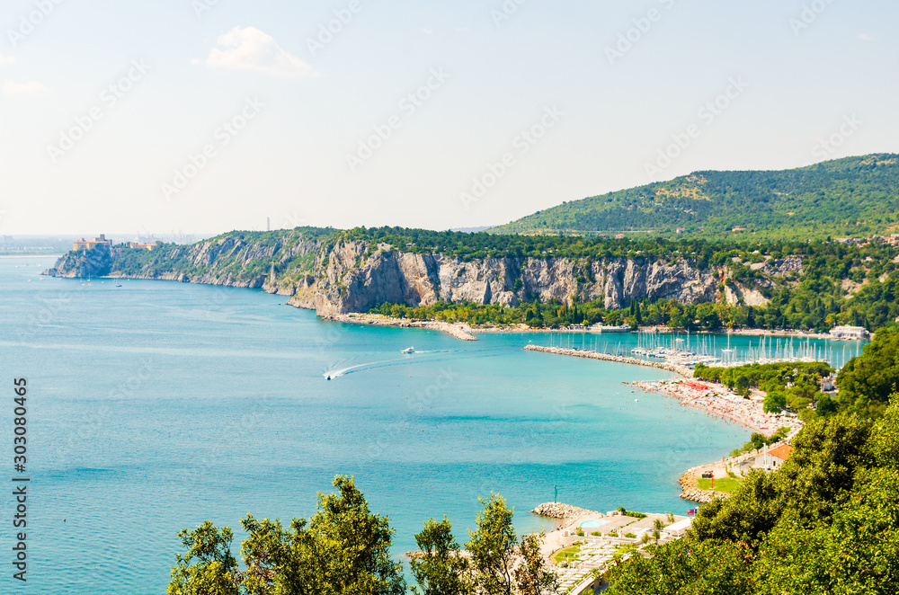 View at Bay with tourist resort in gulf of Trieste near town Sistiana, Italy, Europe. Travel destination