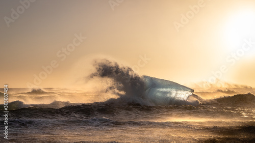 Wave crashing on iceberg in Diamond Beach, Iceland.