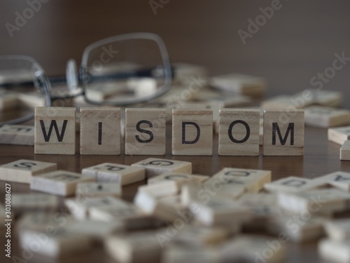 Wisdom the word or concept represented by wooden letter tiles photo