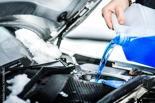 Pouring antifreeze.  Antifreeze liquid for washing car screen. photo