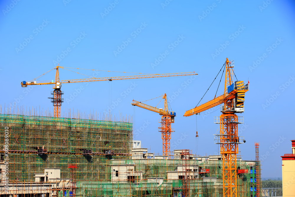Tower cranes build residential buildings
