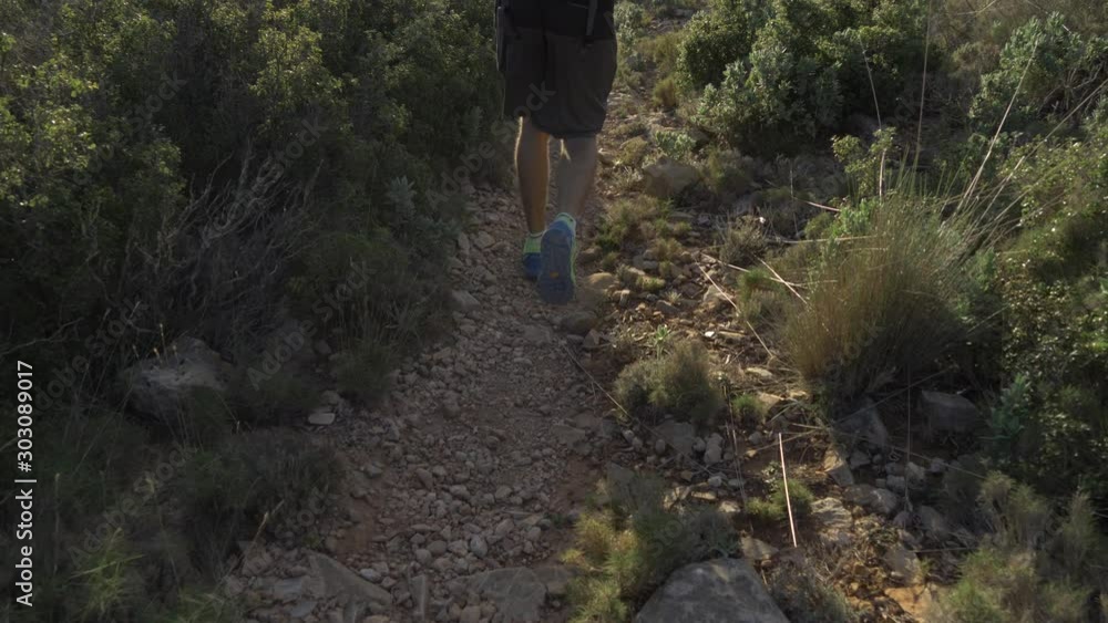 man walking in the mountains during the sunrise in the morning man walking in the mountains during the sunrise in the morning